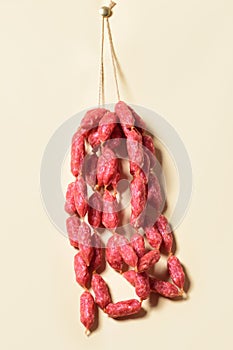 Sticks salami or sausages hanging on the ropes.