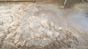 Sticky brown foam on slurry surface. Sewage treatment plant under city is clearing all waste water before being released to river