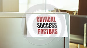 Sticky note on the computer. Text CRITICAL SUCCESS FACTORS