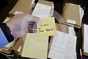 Sticky Note in Hand Businessman Desk Files Folder Working Love Your Work