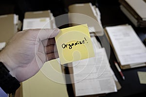 Sticky Note in Hand Businessman Desk Files Folder Working Organize