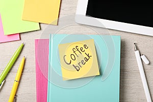 Sticky note with phrase Coffee Break, stationery and tablet on light wooden table, flat lay