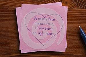 Sticky note with text A face means little,if you have an ugly hea photo