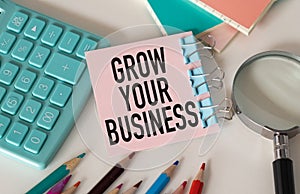 Sticky note with the text Grow Your Business on desk. Acquiring new talents in order to strengthen your skill set concept. Top