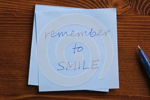 Sticky note with text remember to smile