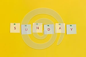 Sticky note with text Sunday on yellow background