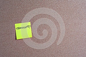 Sticky Note with Thoughts on a Corkboard