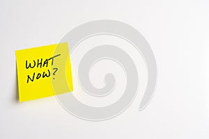 Sticky Note with What Now on a White Background