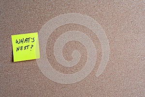 Sticky Note with What\'s Next on a Corkboard