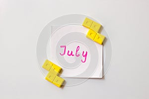 Sticky note on the white background. Business/education memo summer planning. Summer months motivation notes. July
