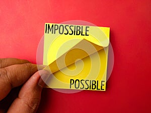 Sticky note with the word IMPOSSIBLE POSSIBLE