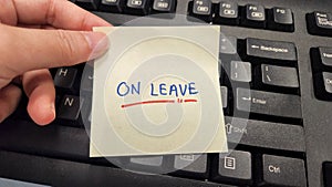 A sticky note with the words On Leave written