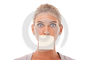 Sticky note, wow and shocked face of woman with covered mouth isolated against a studio white background. Portrait of