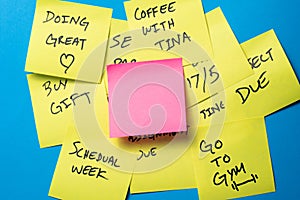Sticky Notes on a Blue Wall with Blank Pink Note