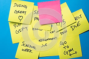 Sticky Notes on a Blue Wall with Blank Pink Note