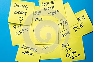 Sticky Notes on a Blue Wall with Blank Yellow Note