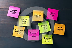 Sticky notes with busy woman schedule