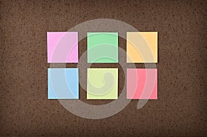 Sticky notes on fiberboard background photo