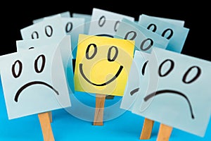 Sticky notes with hand drawn Smiley face and Sad faces. Positive way of thinking concept. Positive overcomes negative