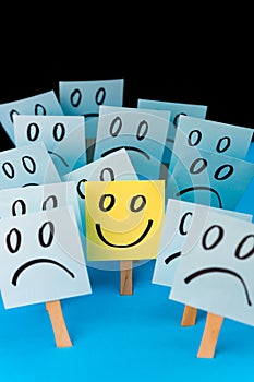 Sticky notes with hand drawn Smiley face and Sad faces. Positive way of thinking concept. Positive overcomes negative