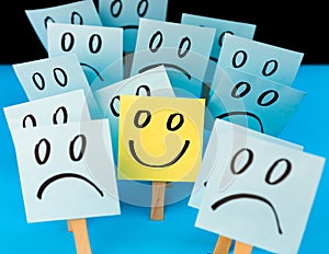 Sticky notes with hand drawn Smiley face and Sad faces. Positive way of thinking concept. Positive overcomes negative