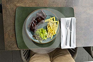 Sticky oven barbecue ribs served with french fries