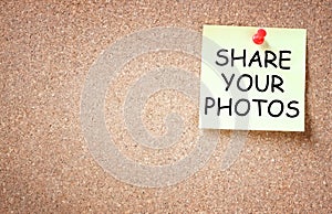 Sticky pined to cork board with the phrase share your photos