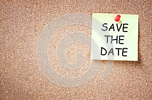 Sticky pinned to cork board with the phrase save the date. room for text