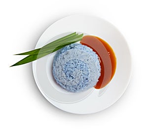 Sticky rice, coconut jam and pandan leaf on plate isolated on white background