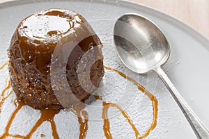 Sticky Toffee Pudding With Caramel Sauce and a Spoon