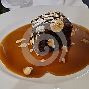 Sticky Toffee Pudding with Sauce on White Plate