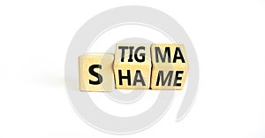 Stigma or shame symbol. Concept words Stigma or Shame on wooden cubes. Beautiful white table white background. Business stigma or
