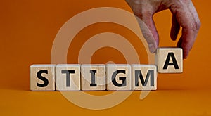 Stigma symbol. Doctor holds cubes with the word `stigma`. Beautiful orange background. Psychological, medical, business and stig photo