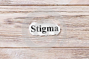 Stigma of the word on paper. concept. Words of Stigma on a wooden background