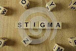 Stigma word from wooden blocks photo