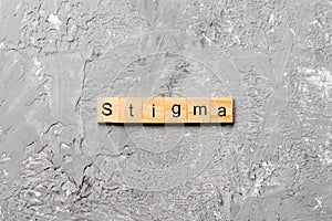 Stigma word written on wood block. stigma text on table, concept