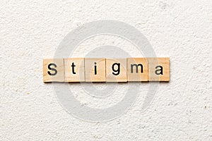 stigma word written on wood block. stigma text on table, concept