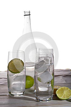 Stil mineral drink water in glass bottle served with three glass photo