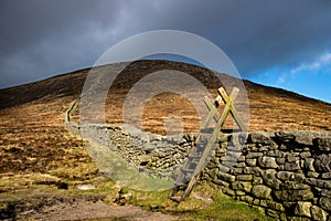 Stile over the Mourne Wall at Hare`s Gap, Mourne Mountains, County Down, Northern Ireland.