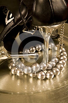 Stilettos and a string of pearls on a tray