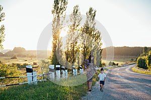 Stilish mother and handsome son having fun on the nature. Happy family concept. Beauty nature scene with family outdoor