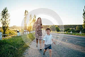 Stilish mother and handsome son having fun on the nature. Happy family concept. Beauty nature scene with family outdoor