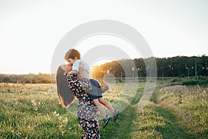 Stilish mother and handsome son having fun on the nature. Happy family concept. Beauty nature scene with family outdoor