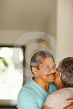 Still full of romance. Portrait of a mature couple embracing at home.
