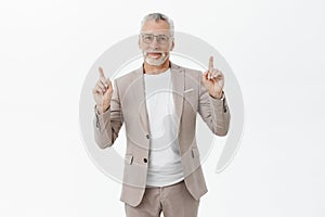 Still hanging on top. Portrait of charming kind and friendly happy relaxed senior businessman in formal elegant suit and