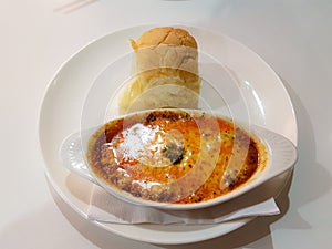 still image of simple cheesy beef lasagne with bun on w