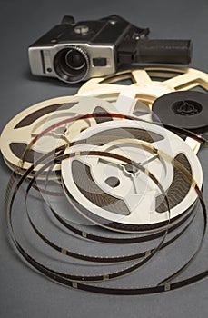 Still life of 8mm cine film reels and old movie camera.