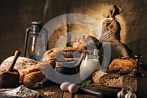 Still life. Agricultural products: eggs, milk, fresh bread on a wooden table. Close-up One trick