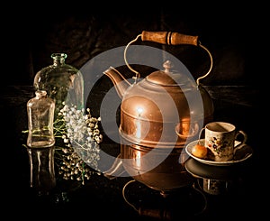 Still life antique brass tea pot, cup, flower