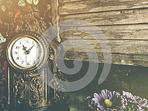 Still life of antique clock on woolden wall background